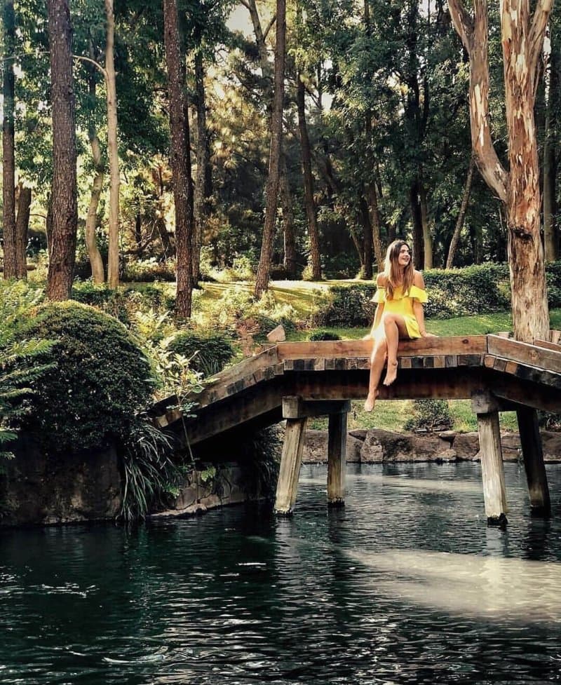 woman on a bridge in bosque los colomos