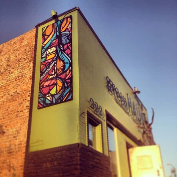 sign and artwork in front of greenHaus