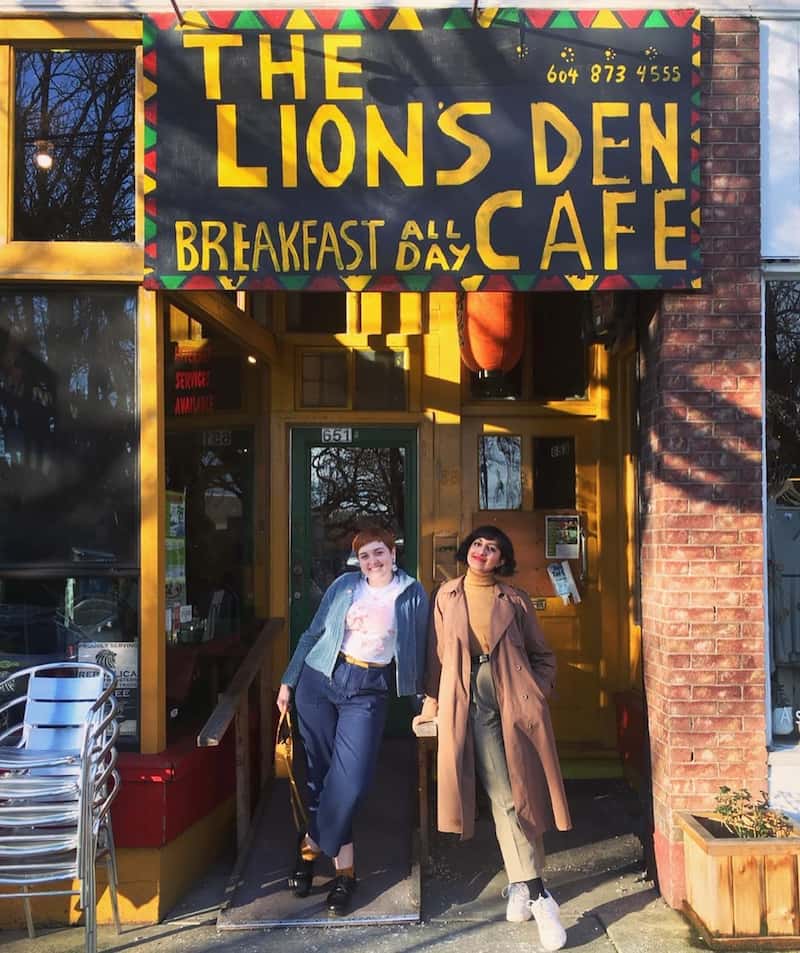 two women in front of the Lion's Den Cafe