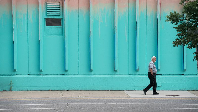 Man in front of mural in RiNo, Denver